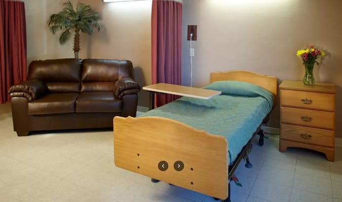 A cozy resident room with a couch and bed