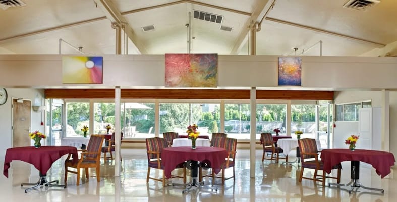 Bright dining area with tables and artwork