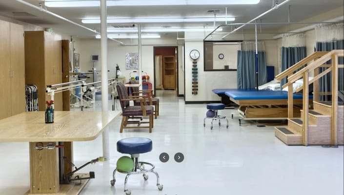 Bright therapy room with equipment and seating