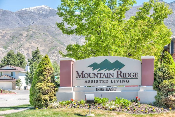 Sign for Mountain Ridge Assisted Living with mountains in background