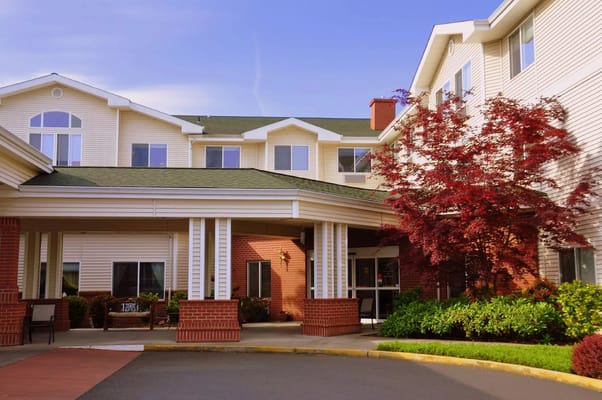 Exterior view of a senior living facility with landscaping