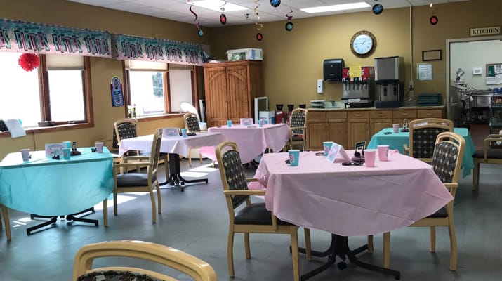 Bright dining area with decorated tables for residents