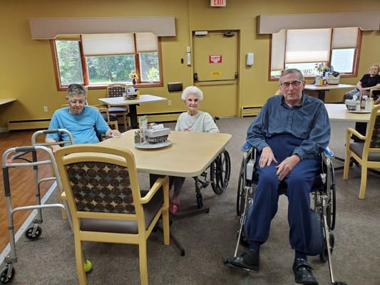 Residents sitting in a bright interior common area