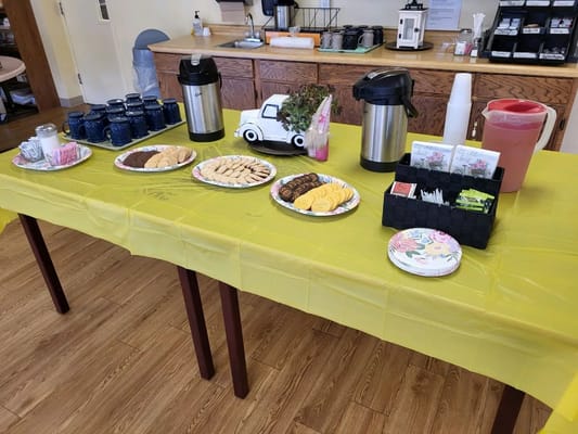 A table set with refreshments and snacks in a common area