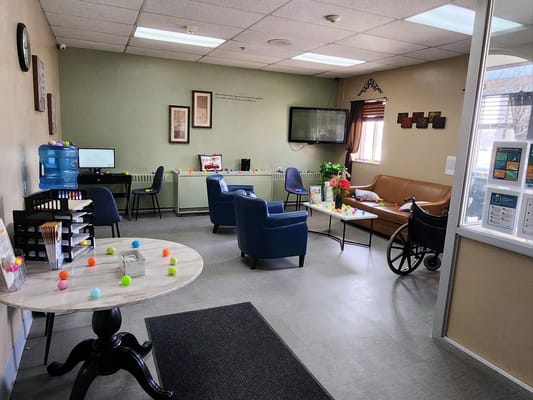 Common area with chairs and a table in a light-filled room