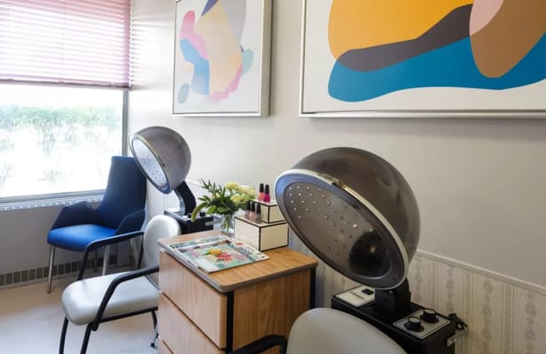 A hair salon area with styling equipment and art