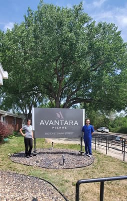 Staff members posing in front of Avantara Pierre sign
