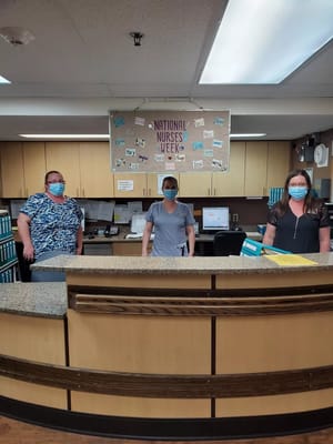 Staff members at the reception desk wearing masks