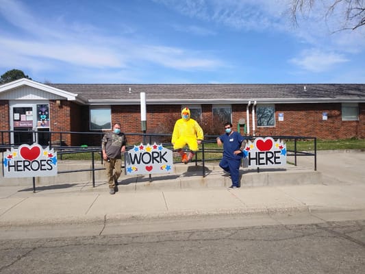 Staff members in costumes promoting community spirit outside the facility
