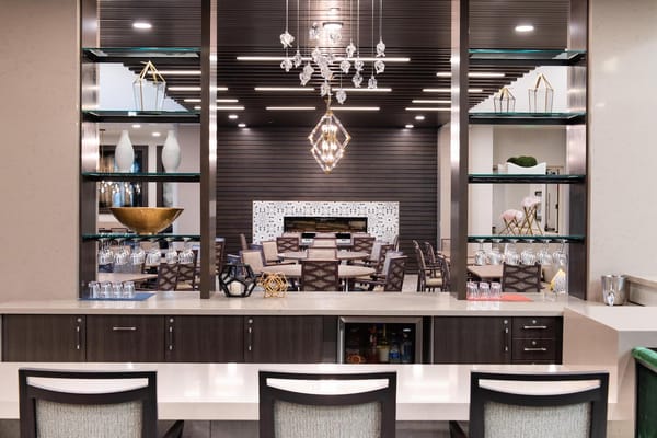 Modern lounge area with tables and shelves in Avanti Living at Peoria