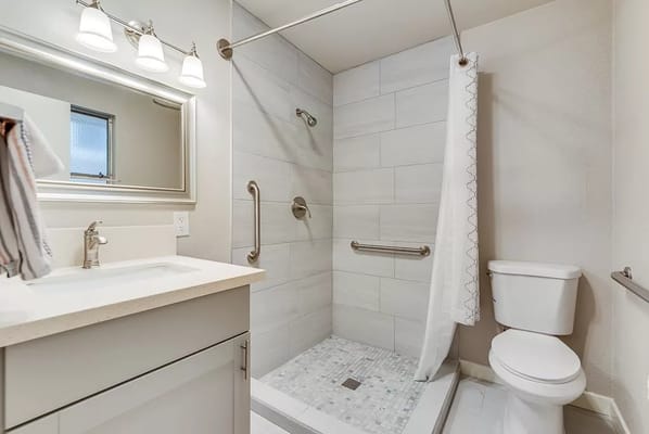 Modern bathroom with grab bars and shower