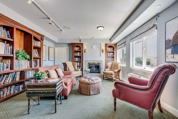 Bright common area with comfortable seating and bookshelves