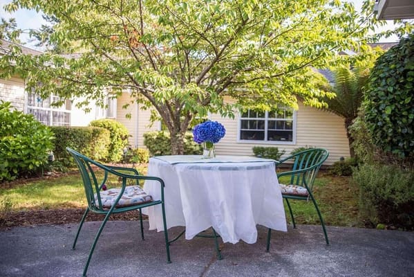 Outdoor table set in a landscaped garden