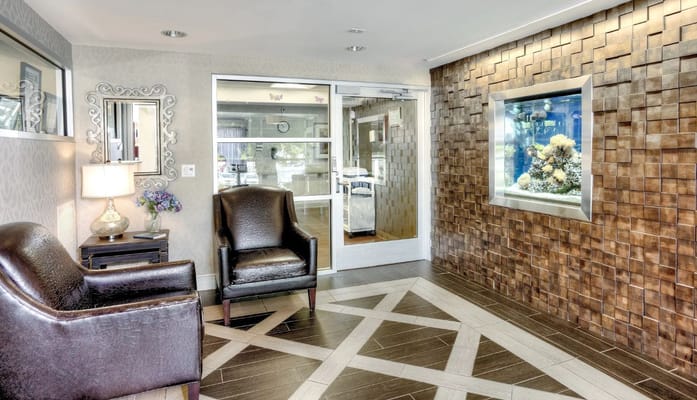 Interior view of a welcoming common area with seating and aquarium