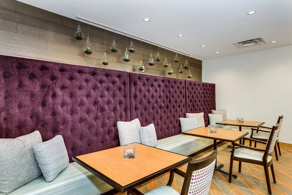 Cozy dining area with purple walls and wooden tables