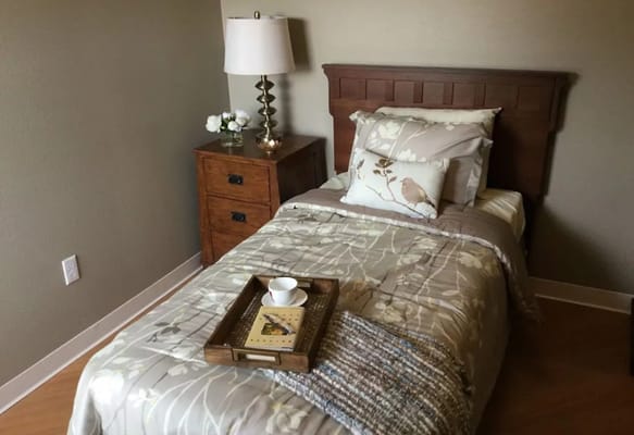 Cozy private resident room with bed and lamp