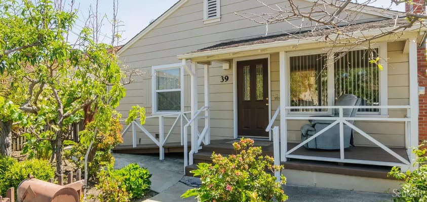 Exterior view of a senior living facility entrance with garden