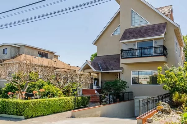 Exterior view of a senior living facility with gardens