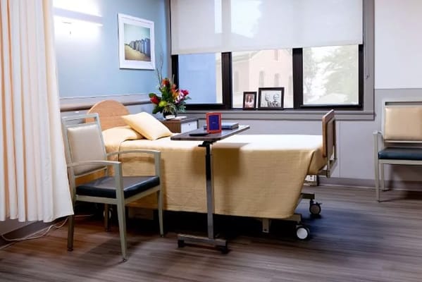 A well-arranged resident room with a bed and sitting area