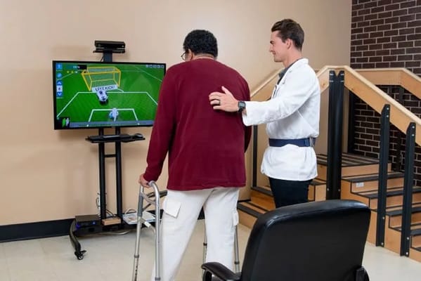 Therapist assisting a resident with rehabilitation activity