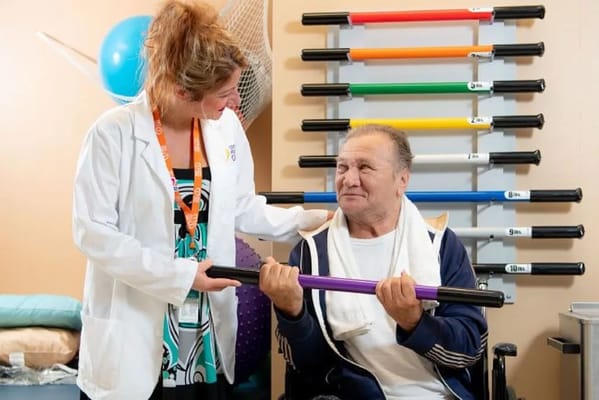 A therapist assisting a resident with rehabilitation exercises