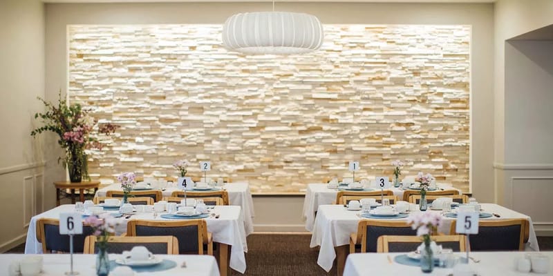 Bright dining area with decorated tables and flower arrangements