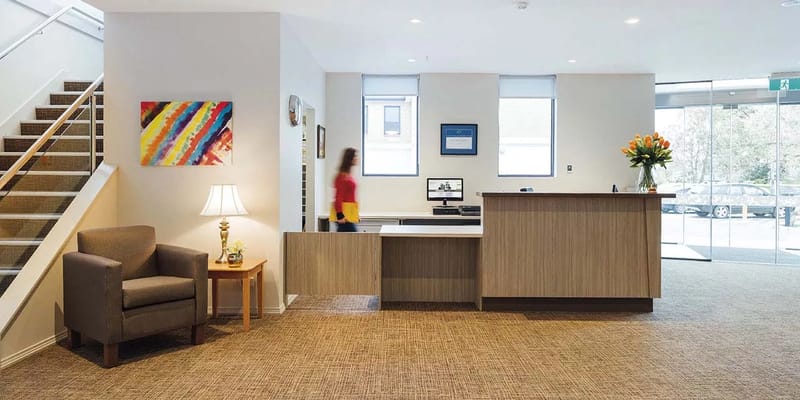 Bright reception area with seating and stairs