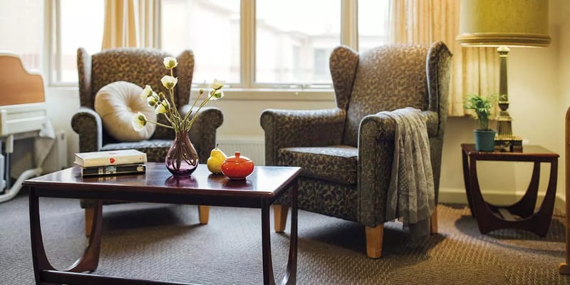 Cozy seating area in a resident's room with decor