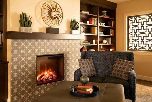 Cozy lounge area with a fireplace and bookshelves