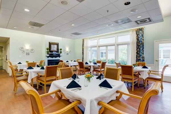 Interior view of dining room with tables set for meals