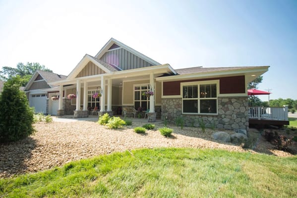Exterior view of a senior living facility with a landscaped front yard
