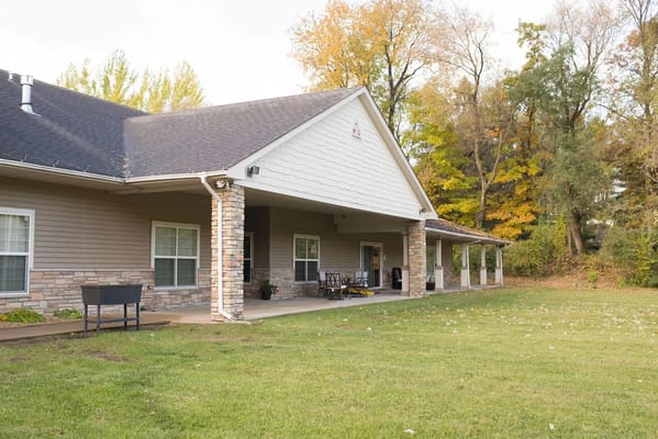 Exterior view of a senior living facility with seating area