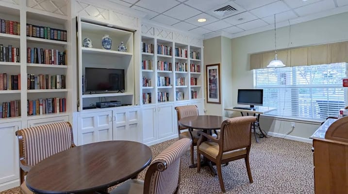 Interior view of a library area with bookshelves and seating.
