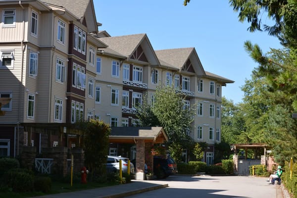 Exterior view of a senior living facility with a garden