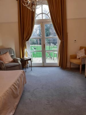 Interior view of a cozy resident room with a patio view