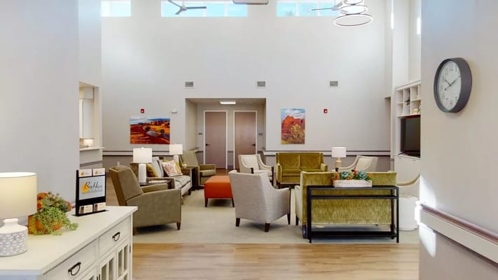 Bright common area with seating and paintings