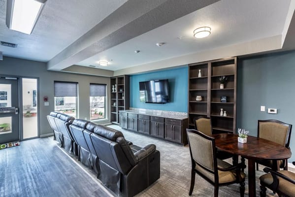 Bright common area with comfortable seating and entertainment unit