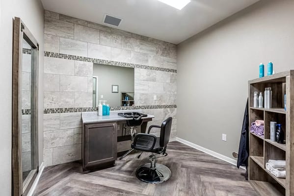 A bright, modern salon area with styling chair