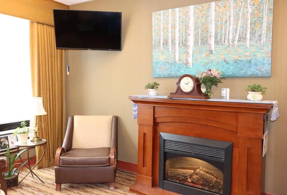 Cozy common area with a fireplace and artwork