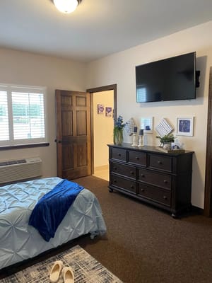 Cozy resident room with a bed and TV