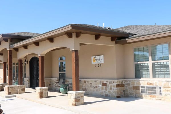 Exterior view of Beehive Homes facility with signage