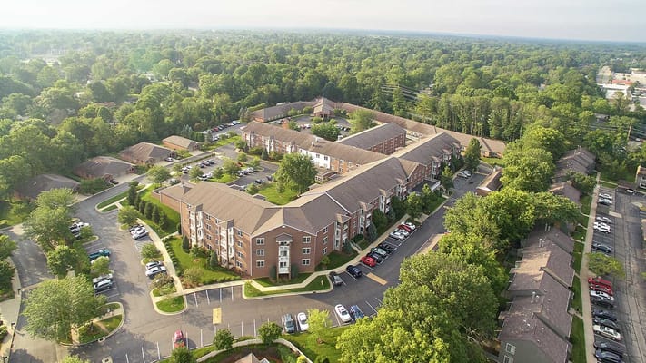 Aerial view of a senior living facility surrounded by greenery