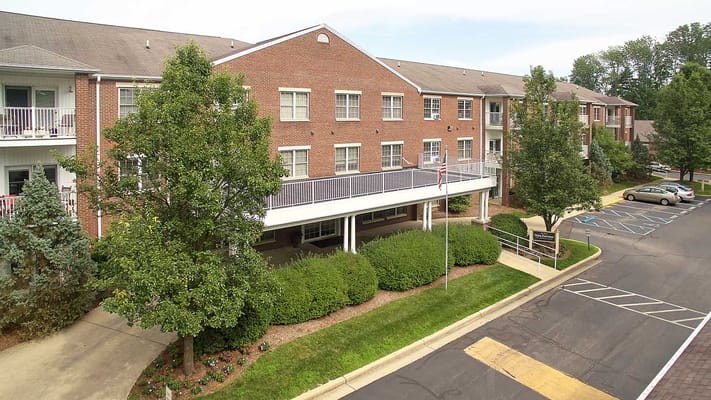 Exterior view of a senior living facility with landscaped gardens