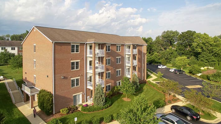 Exterior of a multi-story apartment building at Bell Trace Senior Living Community