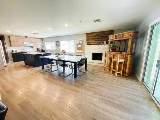 Bright common area with dining table and kitchenette