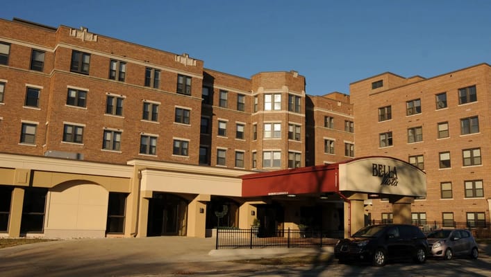 Exterior view of Bella Vista nursing facility with vehicles