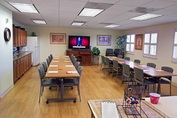 Empty activity room with tables arranged for group gatherings