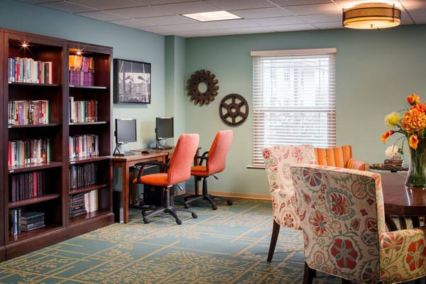 Interior common area with bookshelves and dining table