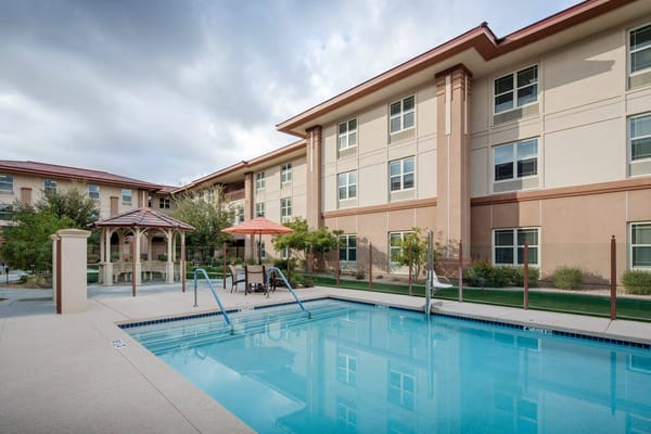 Pool area with seating and shaded gazebo
