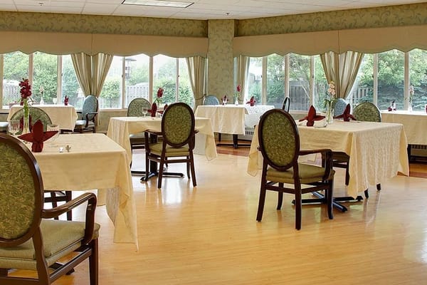 Bright dining room with tables and chairs set for meals